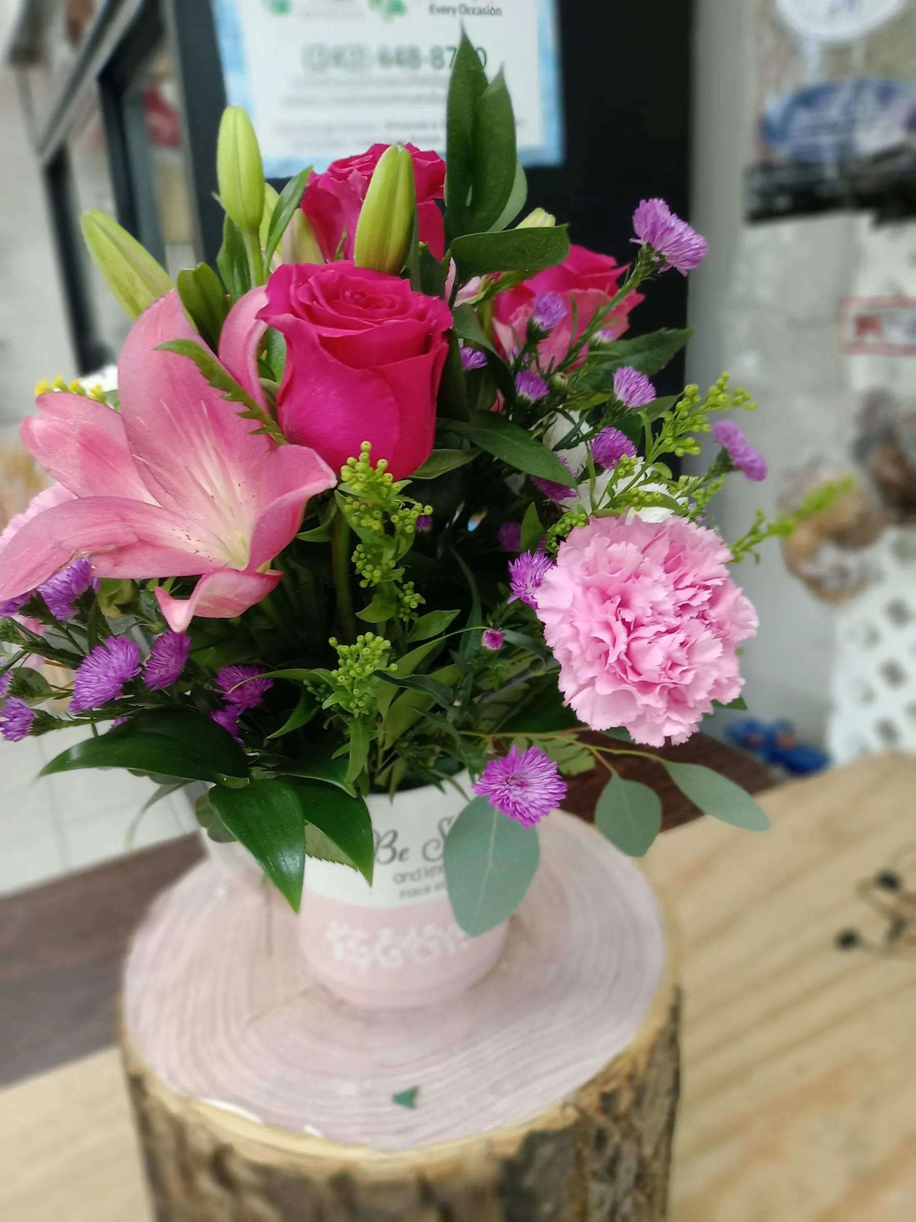 Vase arrangement of pink lilies, roses and carnations in a white ceramic vase by Creative Avenues