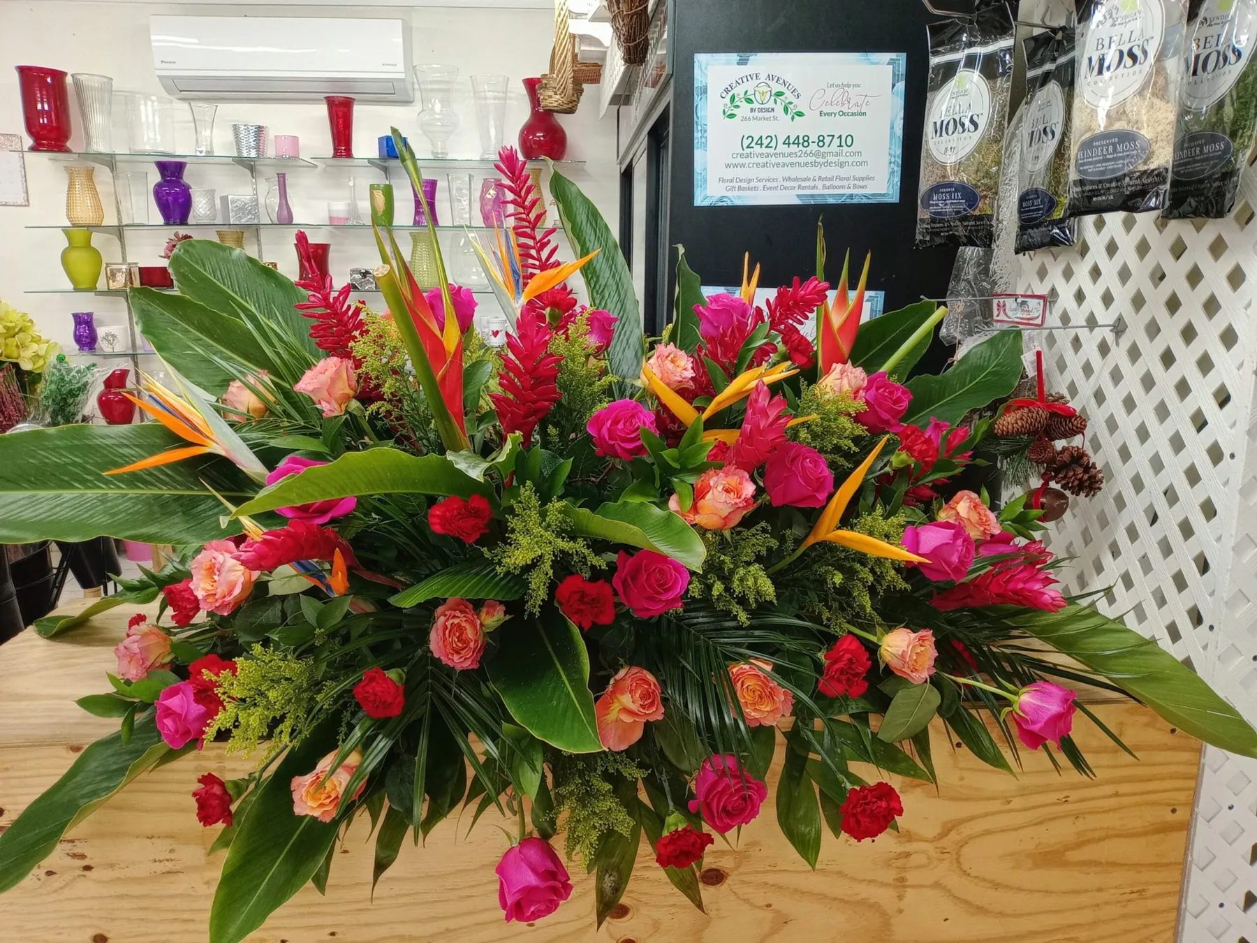Tropical arrangement with heliconia, ginger and palm foliage by Creative Avenues in Nassau, The Bahamas
